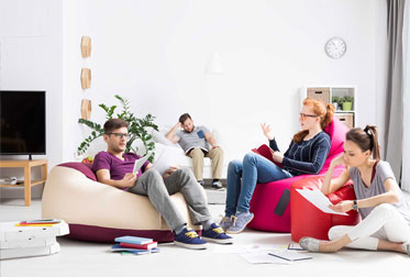 Students sitting on bean bags studying